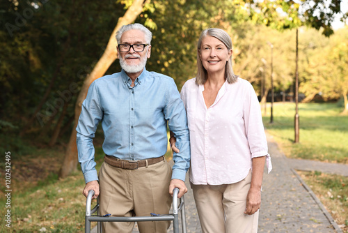 Senior couple with walking frame in park photo