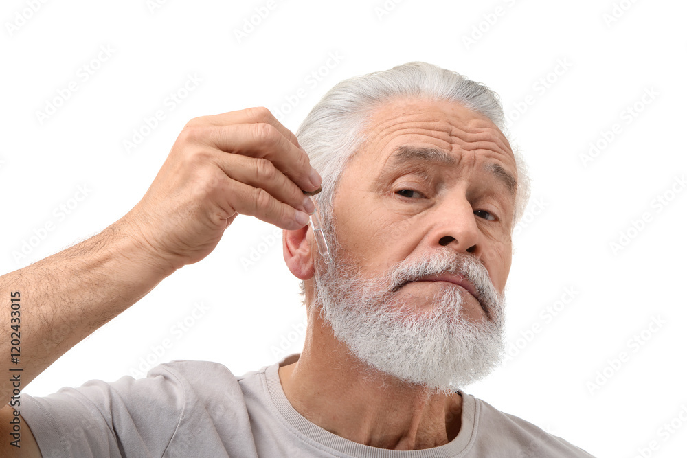Obraz premium Senior man applying serum onto his beard on white background