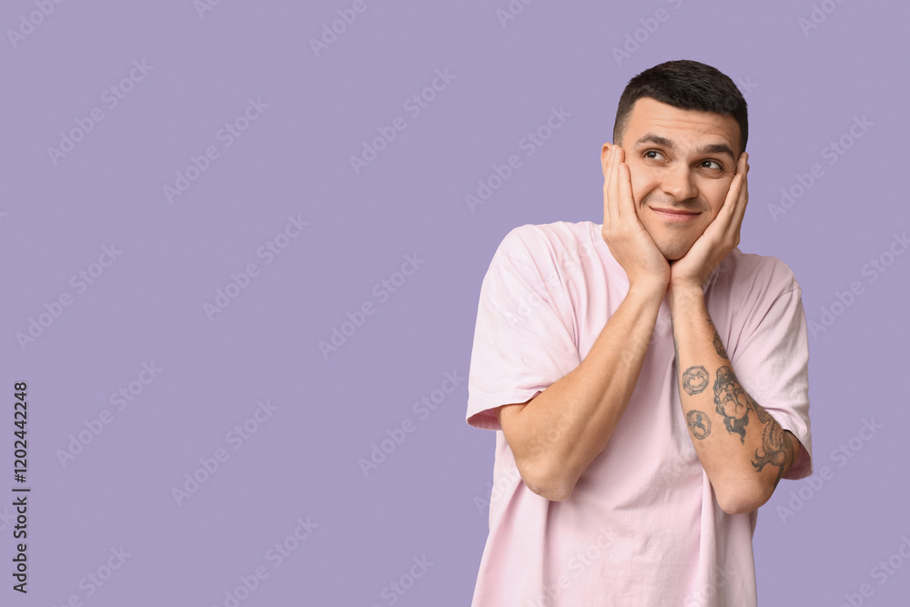 Handsome ashamed young man covering face with hands on lilac background Handsome ashamed young man covering face with hands on lilac background