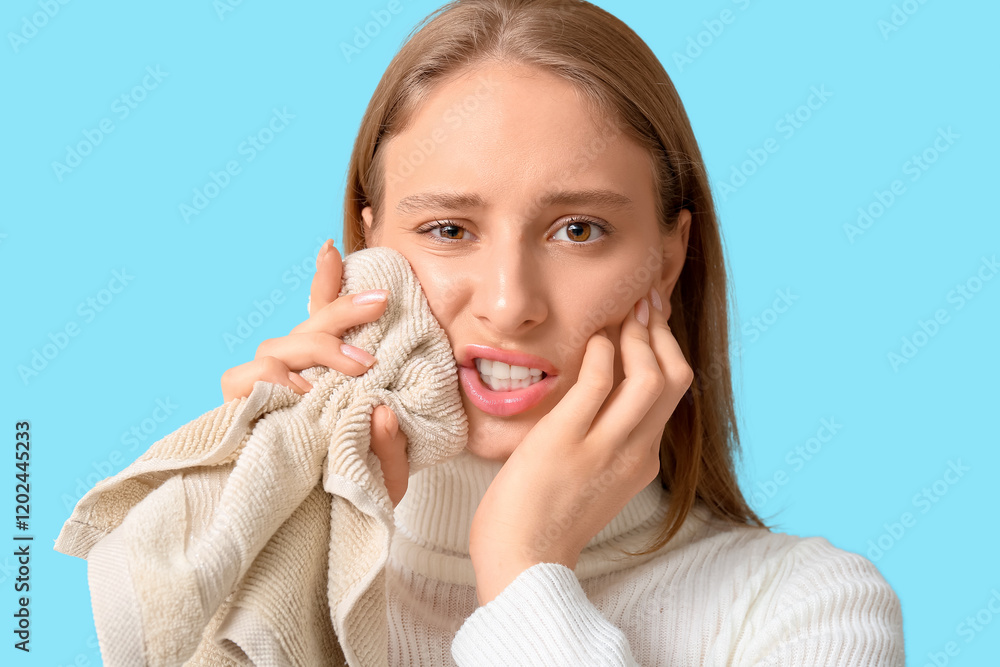Beautiful young woman suffering from toothache with cold compress on blue background Beautiful young woman suffering from toothache with cold compress on blue background