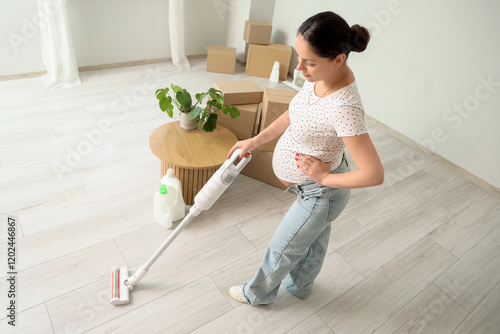 Young pregnant woman cleani...