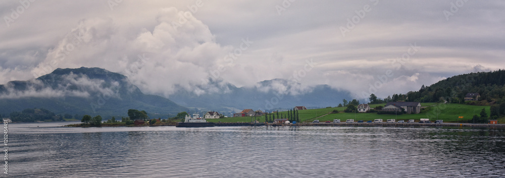Norway Coast Fjord view from boat on ocean. Mountains, forests, waterfalls and small towns. Scandinavia, Norway Norway Coast Fjord view from boat on ocean. Mountains, forests, waterfalls and small towns. Scandinavia, Norway