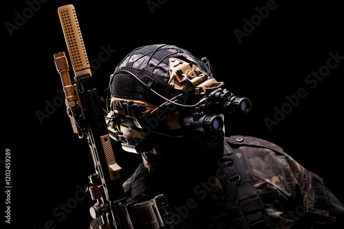 Tactical soldier equipped with night vision gear and rifle in dark setting photo