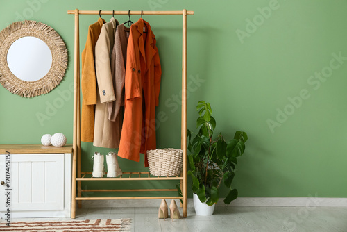 Rack with stylish clothes, ...