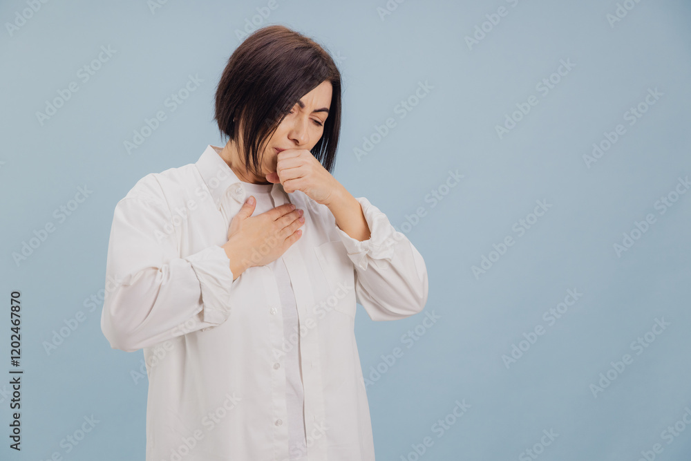 Middle aged woman suffering from cough and chest pain on blue background Middle aged woman suffering from cough and chest pain on blue background