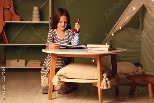 Happy young girl reading bo...