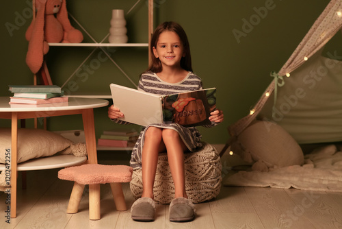 Cute little girl reading fa...