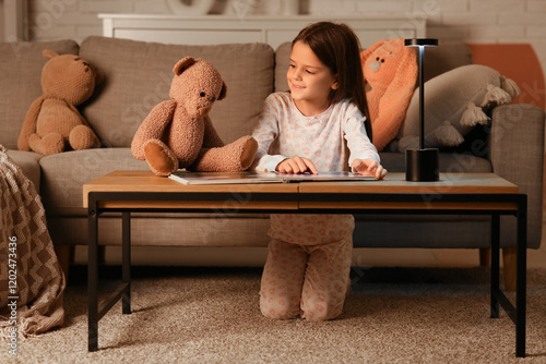 Cute little girl reading fa...