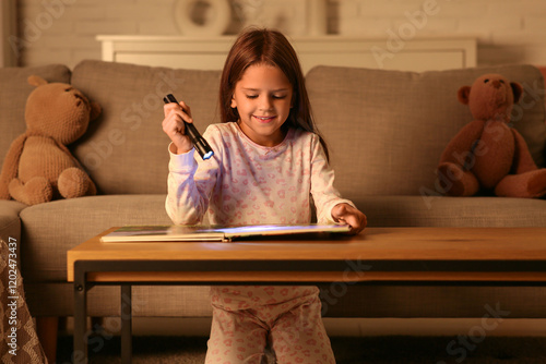 Cute little girl reading fa...