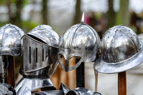 Four helmets are displayed on a table, each with a different design