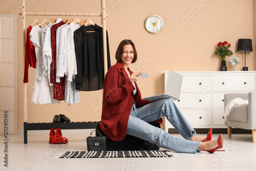 Young woman sitting on pouf...
