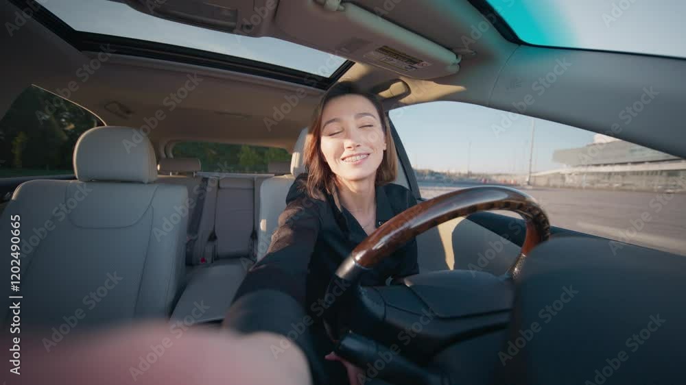 Smiling Caucasian woman with braces sitting in driver’s seat of her car. Waving cheerfully to camera in sunny parking lot. Happy female enjoying casual moment before going back home. Smiling Caucasian woman with braces sitting in driver’s seat of her car. Waving cheerfully to camera in sunny parking lot. Happy female enjoying casual moment before going back home.