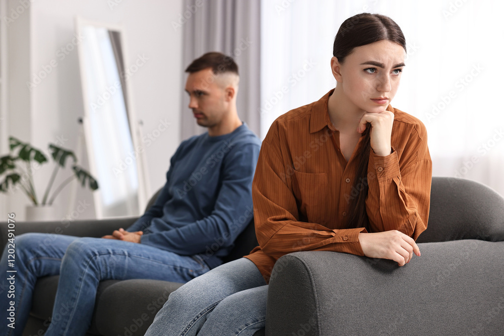 Offended couple ignoring each other at home, selective focus Offended couple ignoring each other at home, selective focus