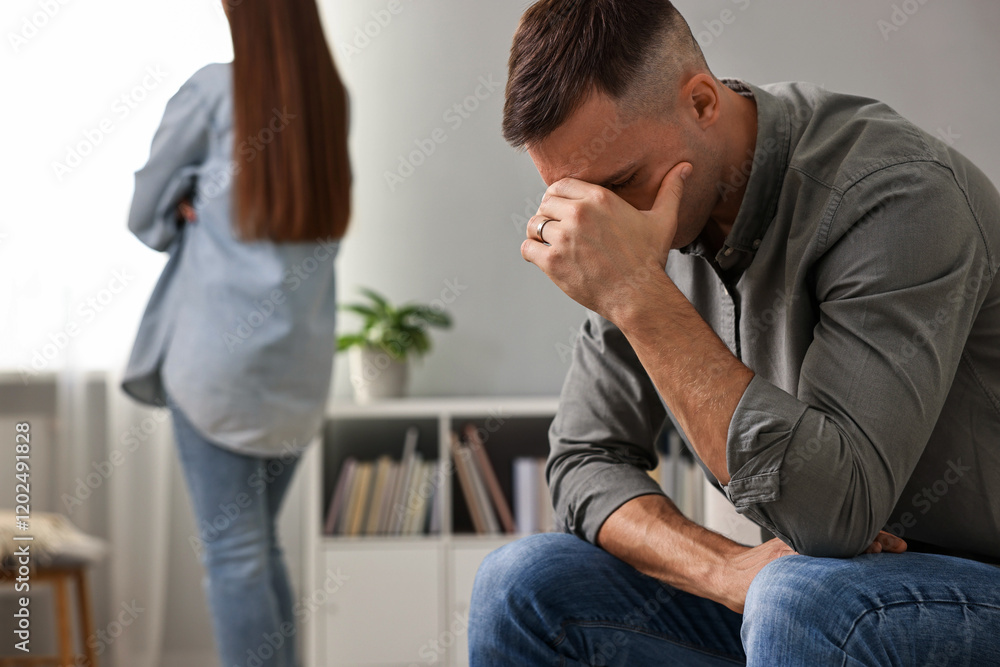 Fototapeta premium Offended couple ignoring each other at home, selective focus