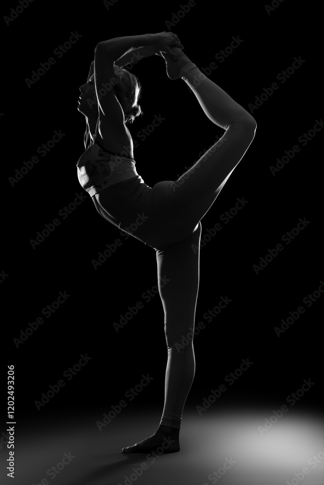 Silhouette of young woman practicing yoga on black background Silhouette of young woman practicing yoga on black background