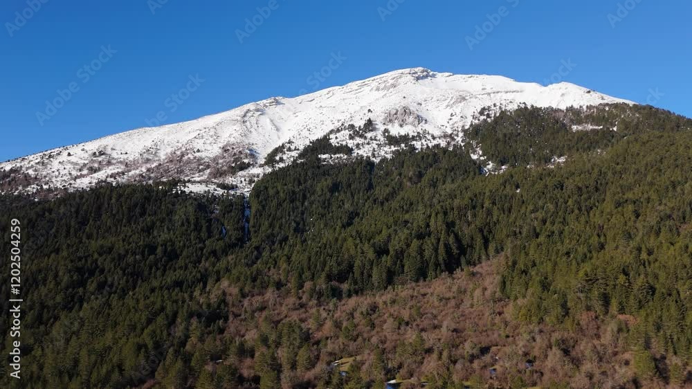 Aerial ascend of Zagori snow capped peaks and lush forest landscapes in Gyftokampos, Greece Aerial ascend of Zagori snow capped peaks and lush forest landscapes in Gyftokampos, Greece