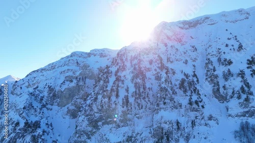 Sunrise over snow capped peaks in Zagori, Gyftokampos, drone upward angle descend photo