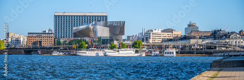 Photography The Stockholm Waterfront Congress Centre rises impressively by the water, showcasing contemporary design against a vibrant blue sky