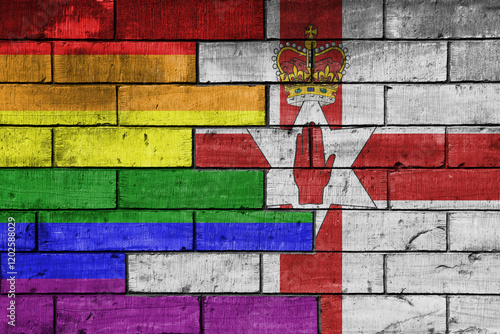 colourful painted big flag of northern ireland and rainbow gay pride flag on a massive old brick wall background. concept