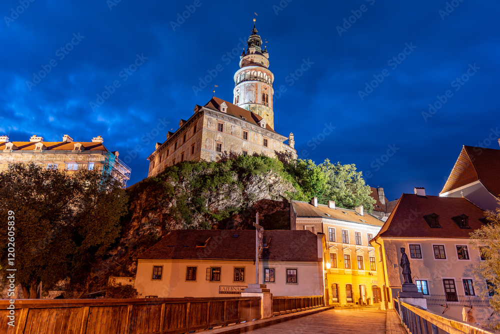 Fototapeta premium Cesky Krumlov Castle Tower stands majestically at night, showcasing its historical architecture under bright lights.
