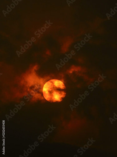 Sun covered by clouds.
