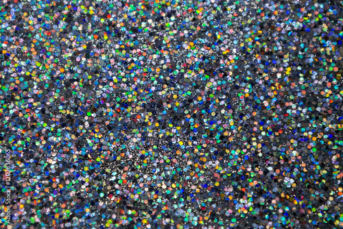 Full frame macro abstract texture background of a sparkling multi color confetti glitter surface
