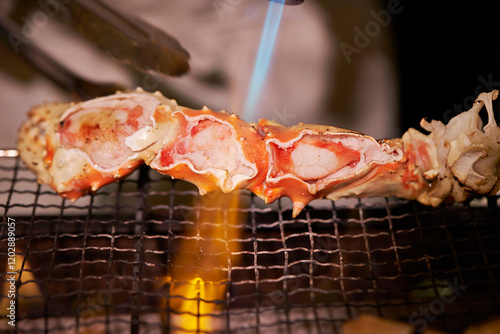 Burn king crab legs with a torch photo