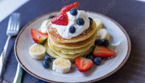 Pancakes decorated with cream and fruit photo