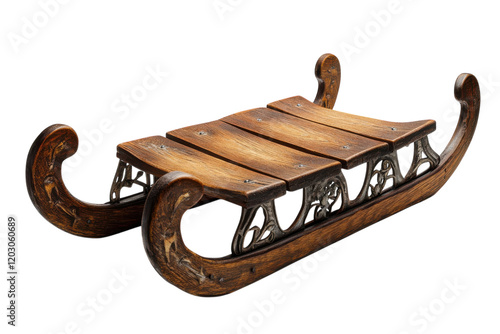 Traditional wooden sled resting on a flat surface with ornate details and curved design, ready for winter activities photo