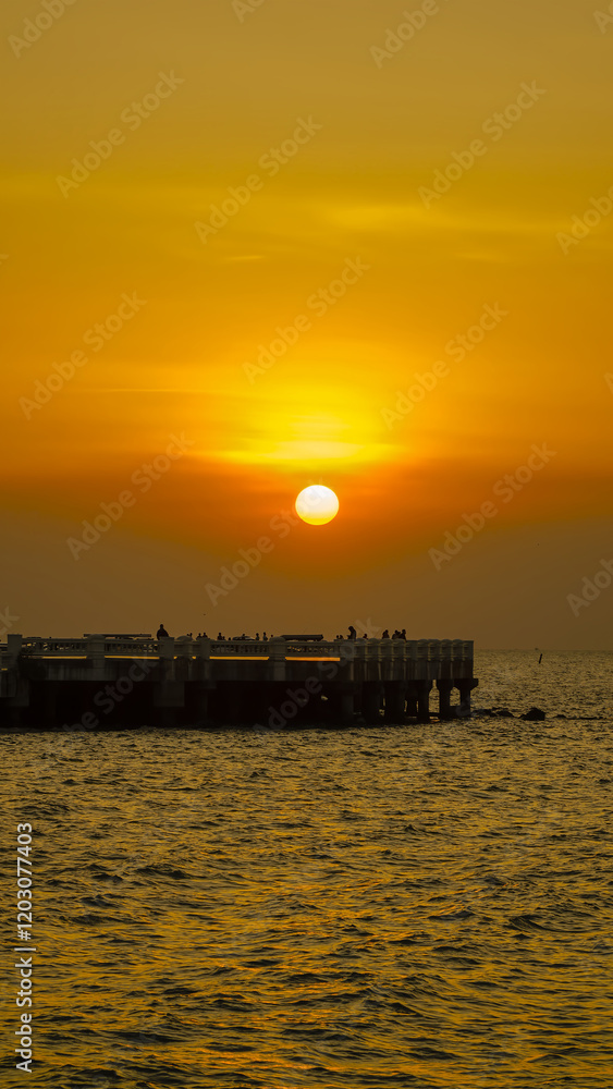 pier during sunset over the sea.Sunset View of Bangsaen Beach, Chonburi Thailand.Vertical. pier during sunset over the sea.Sunset View of Bangsaen Beach, Chonburi Thailand.Vertical.