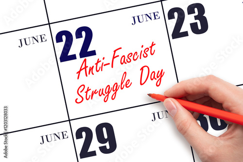 June 22. Hand writing text Anti-Fascist Struggle Day on calendar date. Save the date. photo