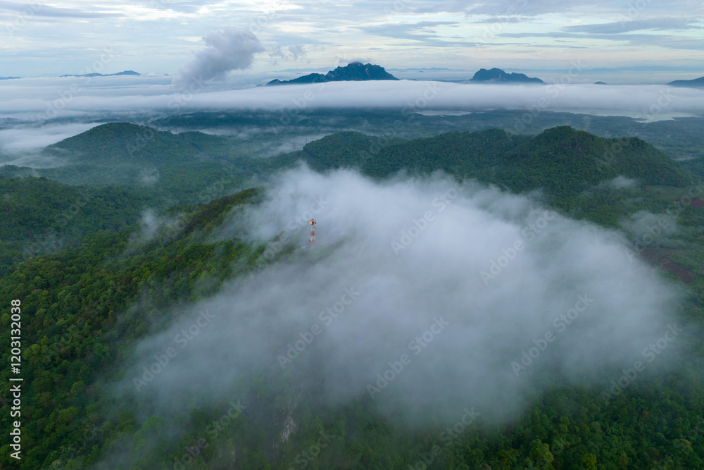 Naklejka premium Aerial view fog in the forest and mountains and the transmission towers. Repeater station.