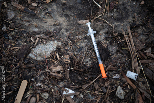 Wallpaper Mural Used hypodermic needle laying amongst organic matter Torontodigital.ca