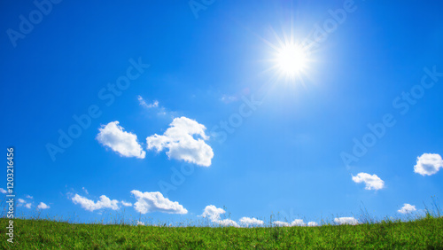 Bottom up view of blue sky with shining sun White fluffy clouds on a blue sky in spring season