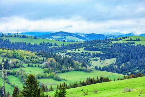 Obraz na płótnie Lush green hills embrace the tranquil sky in a serene landscape of rolling mountains w salonie
