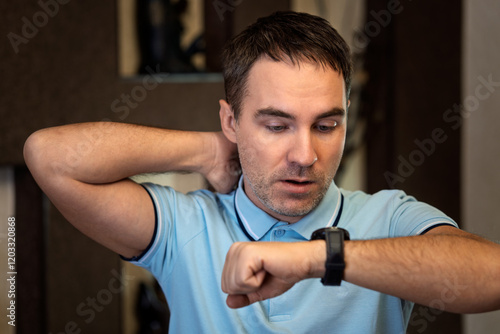 shocked businessman with hand watch. man checking time. wristwatch on male hand. the concept of being late for work, breaking deadlines in business, a hard deadline. photo