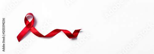 Red ribbons, HIV awareness concept, world AIDS day, world hypertension day, world cancer day with copy space over white background.