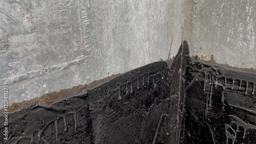 Waterproofing a concrete wall with liquid bitumen