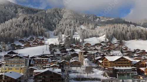 Fast Aerial View of Church in Adelboden, Switzerland in winter