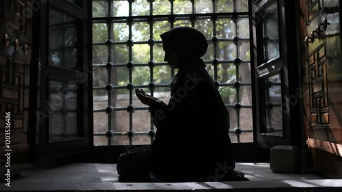 Muslim woman silhouette in mosque