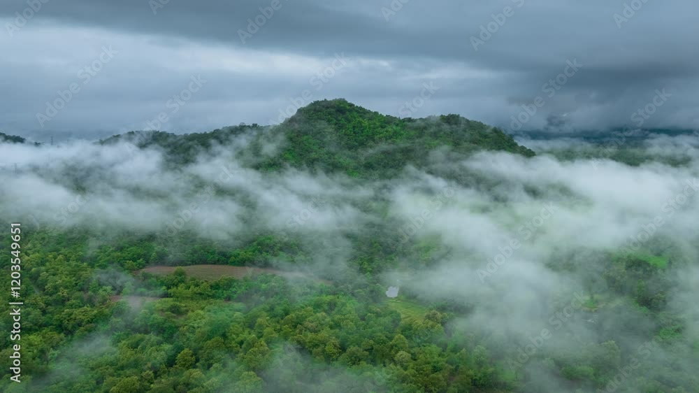 Aerial view of a beautiful landscape in northern Thailand, captured in a 4K hyperlapse video featuring white fog or clouds moving over the green forest below.
Aerial view of a beautiful landscape in northern Thailand, captured in a 4K hyperlapse video featuring white fog or clouds moving over the green forest below.