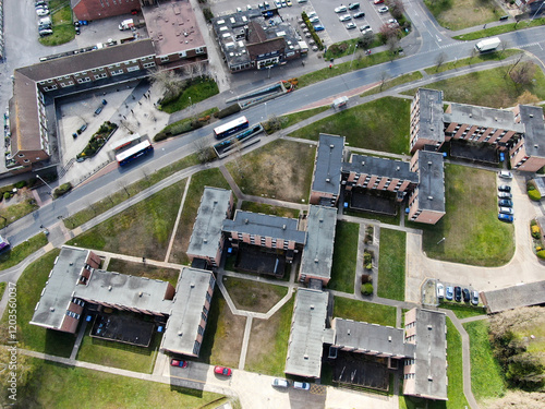 aerial picture of modern apartment flats in an H shape and two buses on a nearby road photo