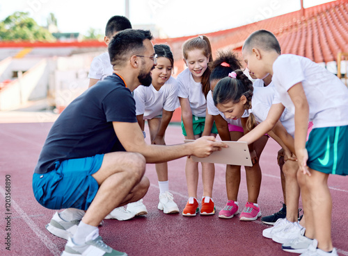 Fototapeta Naklejka Na Ścianę i Meble -  child sport athlete competition running coach teamwork exercise kid fitness training athletic young active girl game group play team childhood school action exercising