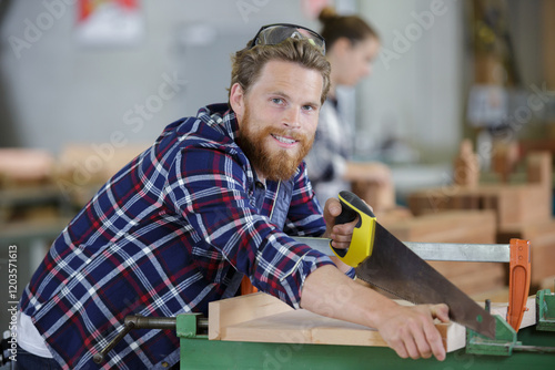 skilled craftsman cutting a wooden plank photo