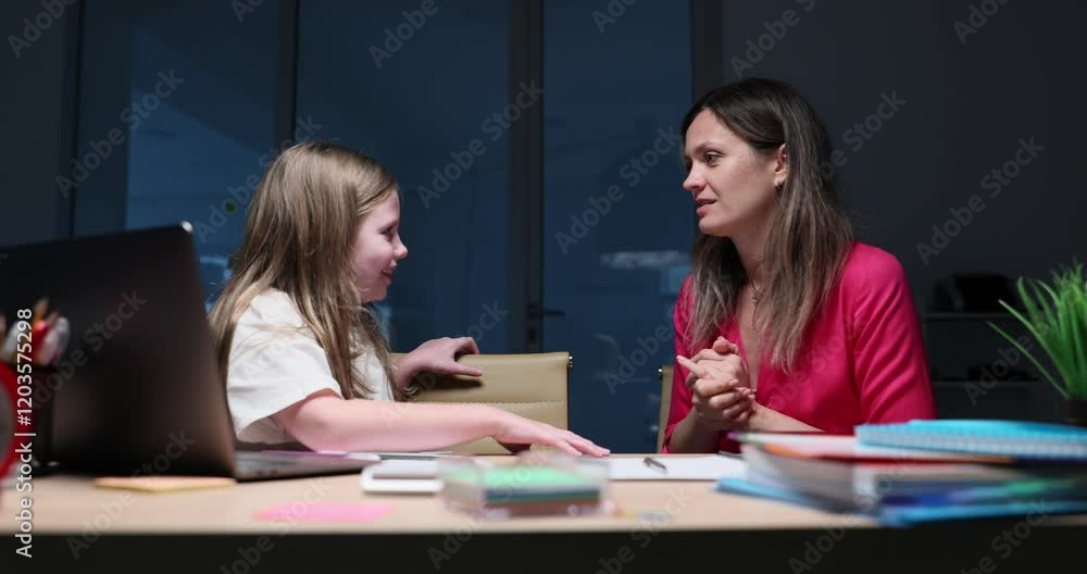 Stressed mother criticizes daughter academic performance leaning over desk with laptop and books. Intense family communication challenge slow motion Stressed mother criticizes daughter academic performance leaning over desk with laptop and books. Intense family communication challenge slow motion