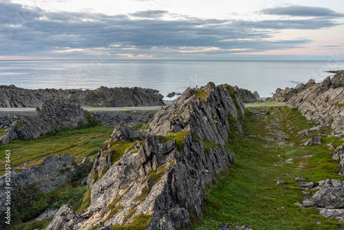 Through the rocks. The road to Hamningberg on a moody summer evening. Finnmark, Norway photo