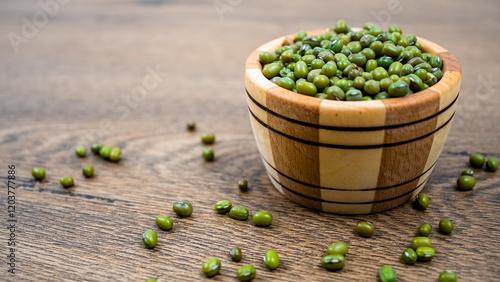 Close-up of beans: green mung beans in a wooden bowl. Natural plant protein in mung beans.