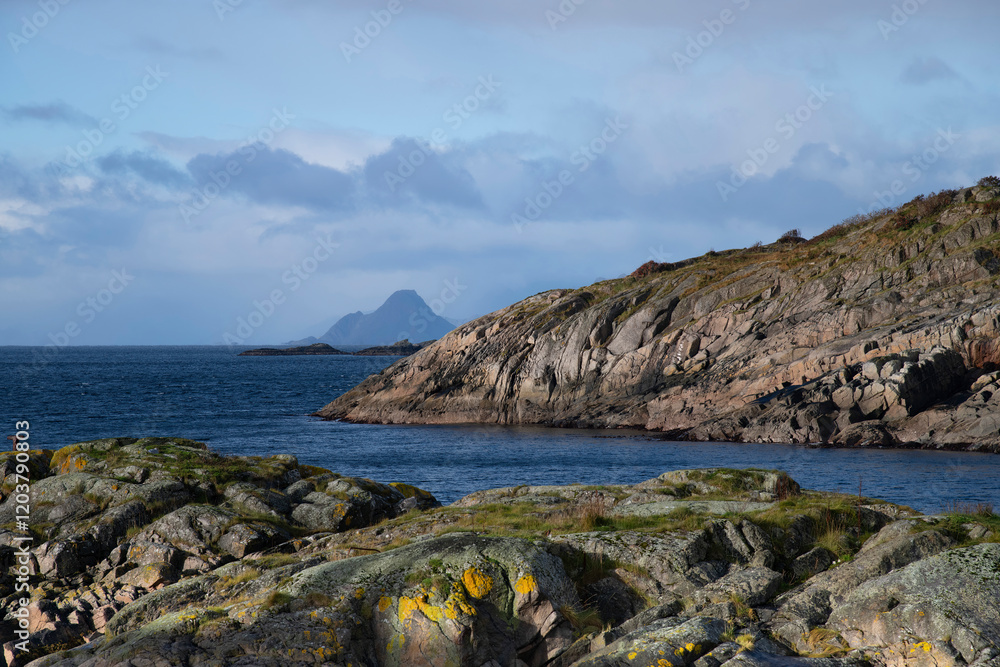 Fototapeta premium Panoramic view over rock formations, water and mountains in outer harbor or Heimsundet of Henningsvaer, Norway on Lofoten island chain archipelago