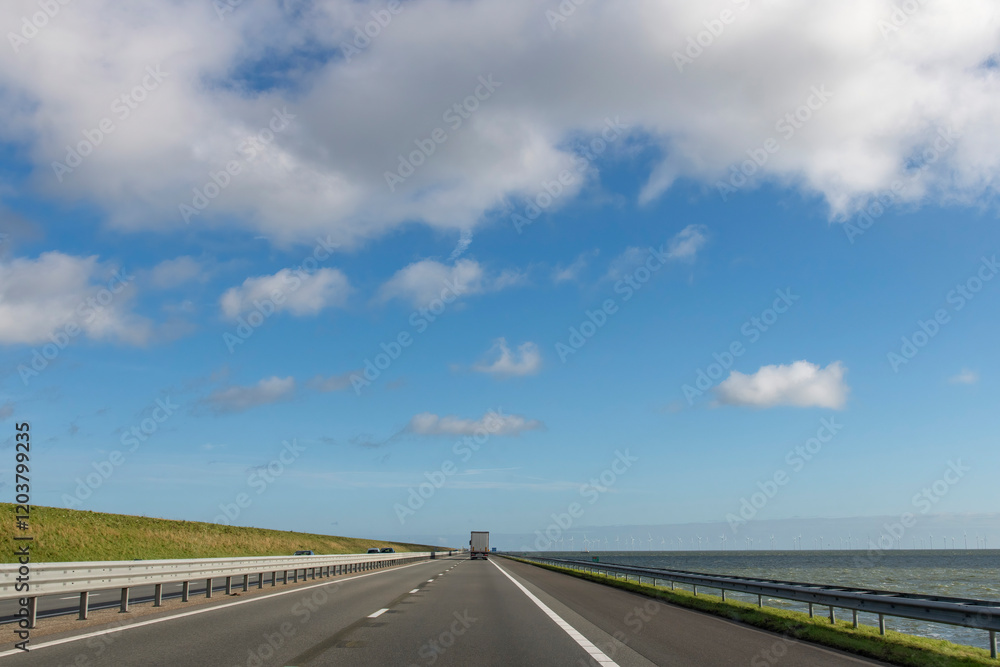Drivers perspective over A7 road between Friesland and North Holland provinces in the Netherlands over the Afsluitdijk (dam separates IJsselmeer lake from Wadden Sea) built to protect against floods Drivers perspective over A7 road between Friesland and North Holland provinces in the Netherlands over the Afsluitdijk (dam separates IJsselmeer lake from Wadden Sea) built to protect against floods