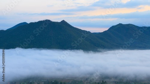 Very early morning landscape of mountain and sea of mist, Thailand. 4K 3840x2160, wide shot and pan right tilt up. Can be establishing shot. Time lapse.